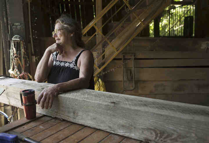 Victoria Goss, founder and president of the Last Chance Corral, stands in the barn that experienced significant storm damage on her property during a storm earlier that week in Athens. Goss founded the Last Chance Corral in 1982, the 501(c)3 charity is devoted to helping foals, horses and ponies recovery from neglect and abuse.   (Brooke LaValley / The Columbus Dispatch)